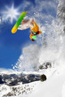 Snowboarder jumping against blue sky