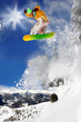 Snowboarder jumping against blue sky