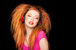 cute curly blonde girl listening to music on big red headphones