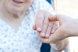 Foto: Senior woman holding hands with caretaker Senior woman holding hands with caretaker
