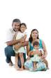 Happy Indian family sitting on white background