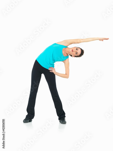 Photo: young woman showing fitness routine, white background young woman showing fitness routine, white background