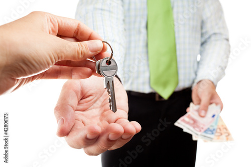 Photo: Business exchange with money and keys. Business exchange with money and keys.