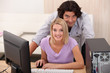 Couple looking at their computer