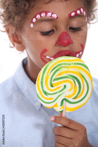 Photo: little boy made-up sucking lollipop little boy made-up sucking lollipop