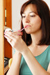 Photo: Young woman applying makeup Young woman applying makeup