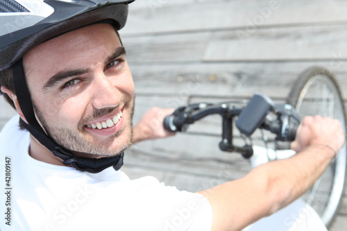 Photo: young man riding bike young man riding bike