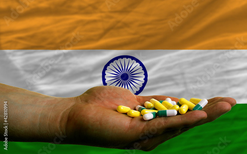 Foto: holding pills in hand in front of india national flag holding pills in hand in front of india national flag