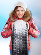Foto: Pretty woman with winter coat and snowy winter tyre Pretty woman with winter coat and snowy winter tyre
