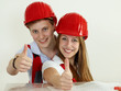 Young worker  fixing up a house and showing thumbs up