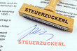 Holzstempel auf Dokument: Steuerzuckerl