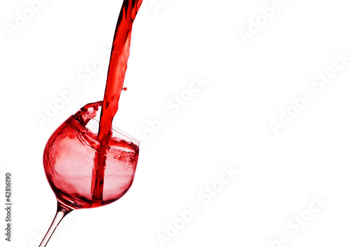 Photo: Rotwein wird in ein Weinglas eingegossen Rotwein wird in ein Weinglas eingegossen