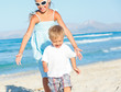 Young girl and boy playing happily at pretty beach