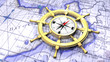 Compass in a ship's wheel over a map