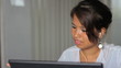 Young Asian Girl Listens To Music At Work