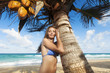 Foto: Young woman relaxing under the palm tree Young woman relaxing under the palm tree
