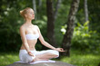 Young girl doing yoga in the park