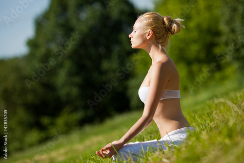 Photo: Young girl doing yoga in the park Young girl doing yoga in the park