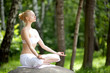 Young girl doing yoga in the park