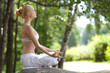 Young girl doing yoga in the park