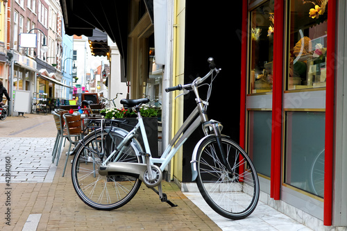 Photo: Bike is parked near shop in Gorinchem. Netherlands Bike is parked near shop in Gorinchem. Netherlands