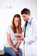 Foto: Latin doctor and a girl looking to tablet PC Latin doctor and a girl looking to tablet PC