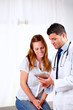 Foto: Handsome doctor and a patient looking to tablet PC Handsome doctor and a patient looking to tablet PC