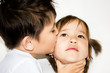 a boy kissing a girl on a white background