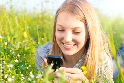 Photo: Beautiful Teenage Girl With Cellphone outdoors. Beautiful Teenage Girl With Cellphone outdoors.