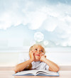 Foto: Portrait of a young girl in school at the desk. Vertical Shot. D Portrait of a young girl in school at the desk. Vertical Shot. D