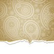 Torn paper with a paisley pattern.