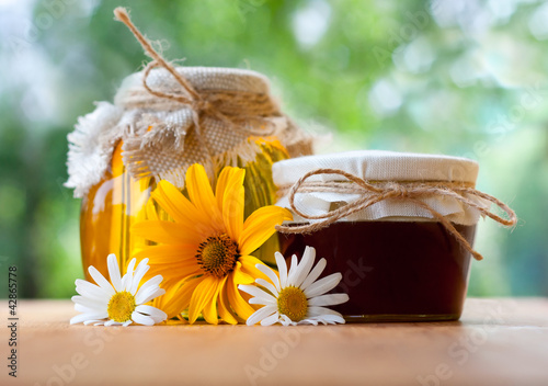 Photo: healthy honey in glass jar with flower healthy honey in glass jar with flower