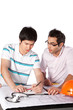 Two Architects Discussing on Blueprints