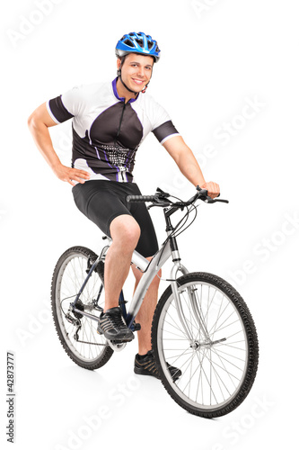 Photo: Male biker with helmet posing on a bike Male biker with helmet posing on a bike
