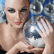Photo: Young woman holding disco ball Young woman holding disco ball