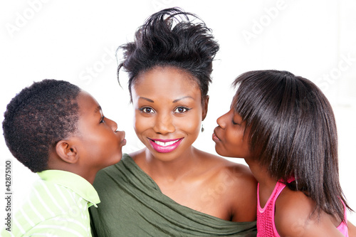 Photo: Smiling mom gets a kiss from loving kids Smiling mom gets a kiss from loving kids