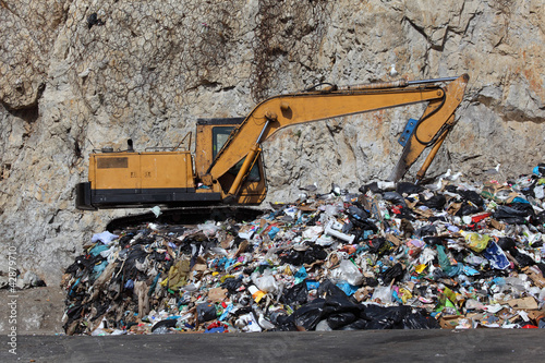 Photo: Excavator at the garbage dump Excavator at the garbage dump