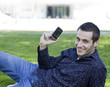 Man holding cell phone against office