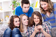 Foto: Surprised friends looking in smart phone Surprised friends looking in smart phone
