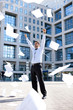 young businessman throwing away his papers