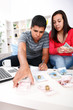 Photo: Young Couple paying bills. Young Couple paying bills.