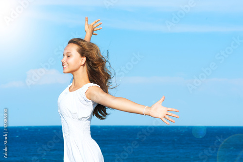 Photo: Beautiful Girl Having Fun on the Beach Beautiful Girl Having Fun on the Beach