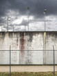 prison walls with barbed wired fence