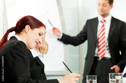 Photo: Business people - presentation within a team Business people - presentation within a team