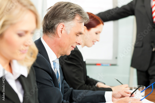 Photo: Business people - presentation within a team Business people - presentation within a team