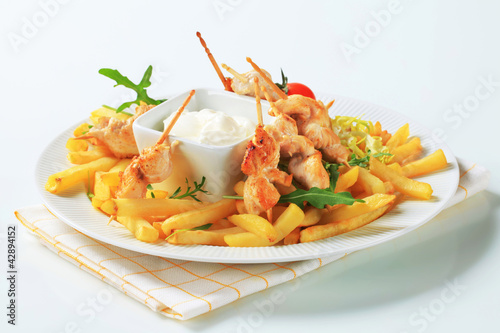 Photo: Chicken satay with French fries Chicken satay with French fries