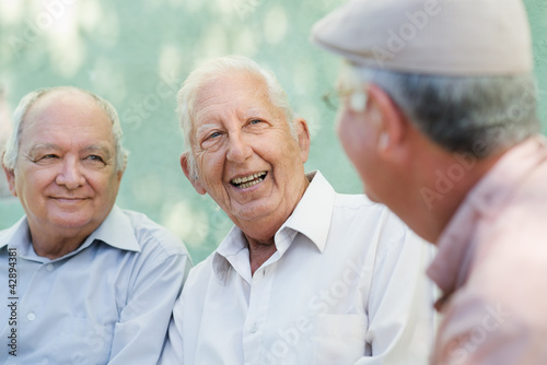 Foto: Group of happy elderly men laughing and talking Group of happy elderly men laughing and talking