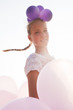 Photo: girl surrounded by balloons by the rays of sunlight girl surrounded by balloons by the rays of sunlight