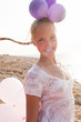 Photo: girl surrounded by balloons by the rays of sunlight girl surrounded by balloons by the rays of sunlight