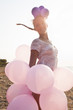 Photo: girl surrounded by balloons by the rays of sunlighty girl surrounded by balloons by the rays of sunlighty